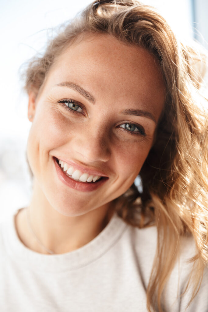 Close up of a smiling young woman standing at the 2021 08 27 22 41 18 utc